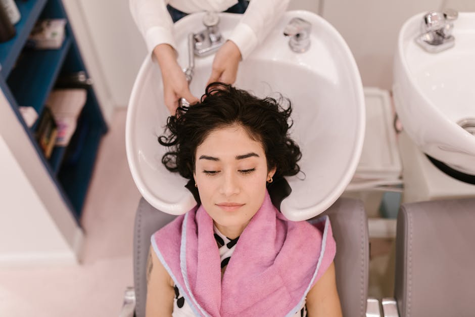 A woman enjoys a relaxing hair wash at a modern hair salon, focusing on self-care